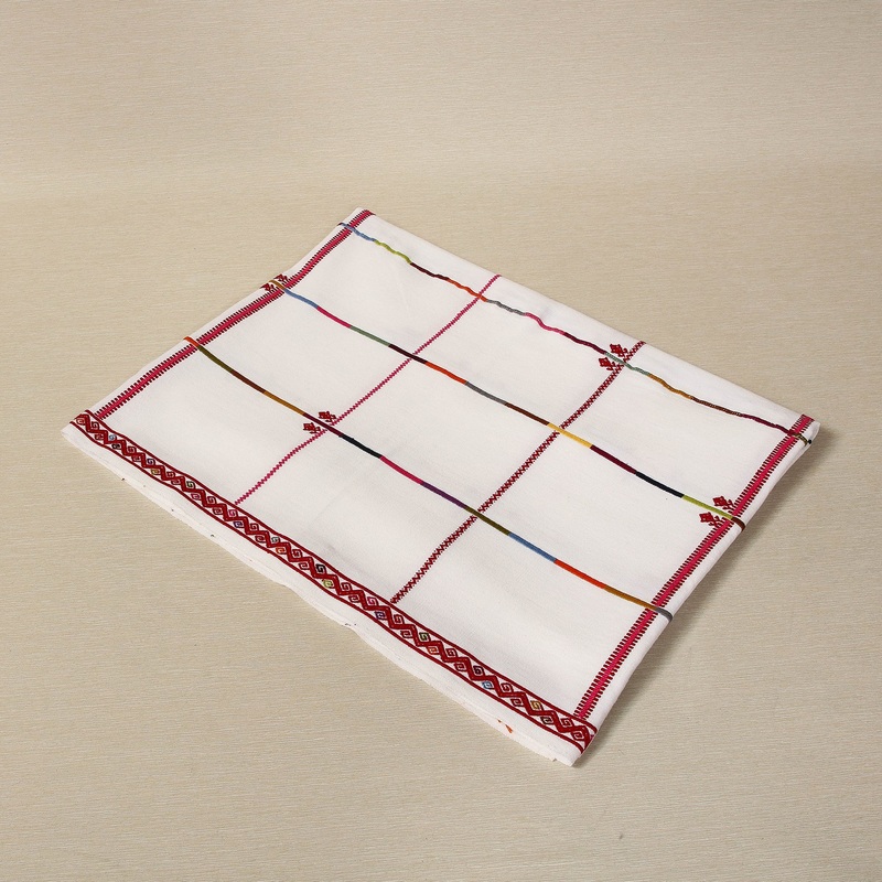 Handwoven tablecloth with embroidered red borders and frog motif